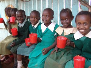 Kenya February 2008 Child in the Kibera Slums having a cup of porridge provided by WFP at the Stara School. Photo: WFP/Marcus Prior