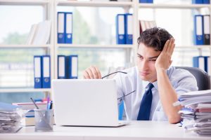 Tired exhausted businessman sitting in the office